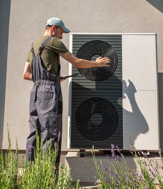 Man checking HVAC equipment outdoors