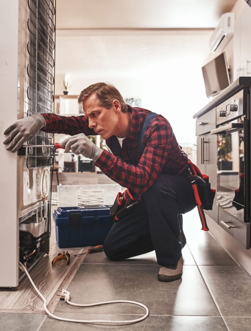 Technician working on refrigerator
