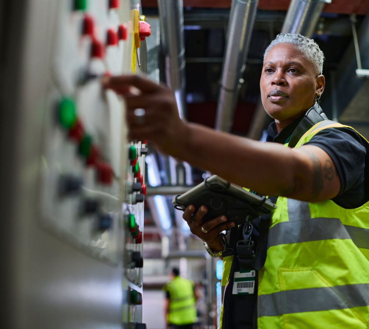 Engineer operating control panel in factory